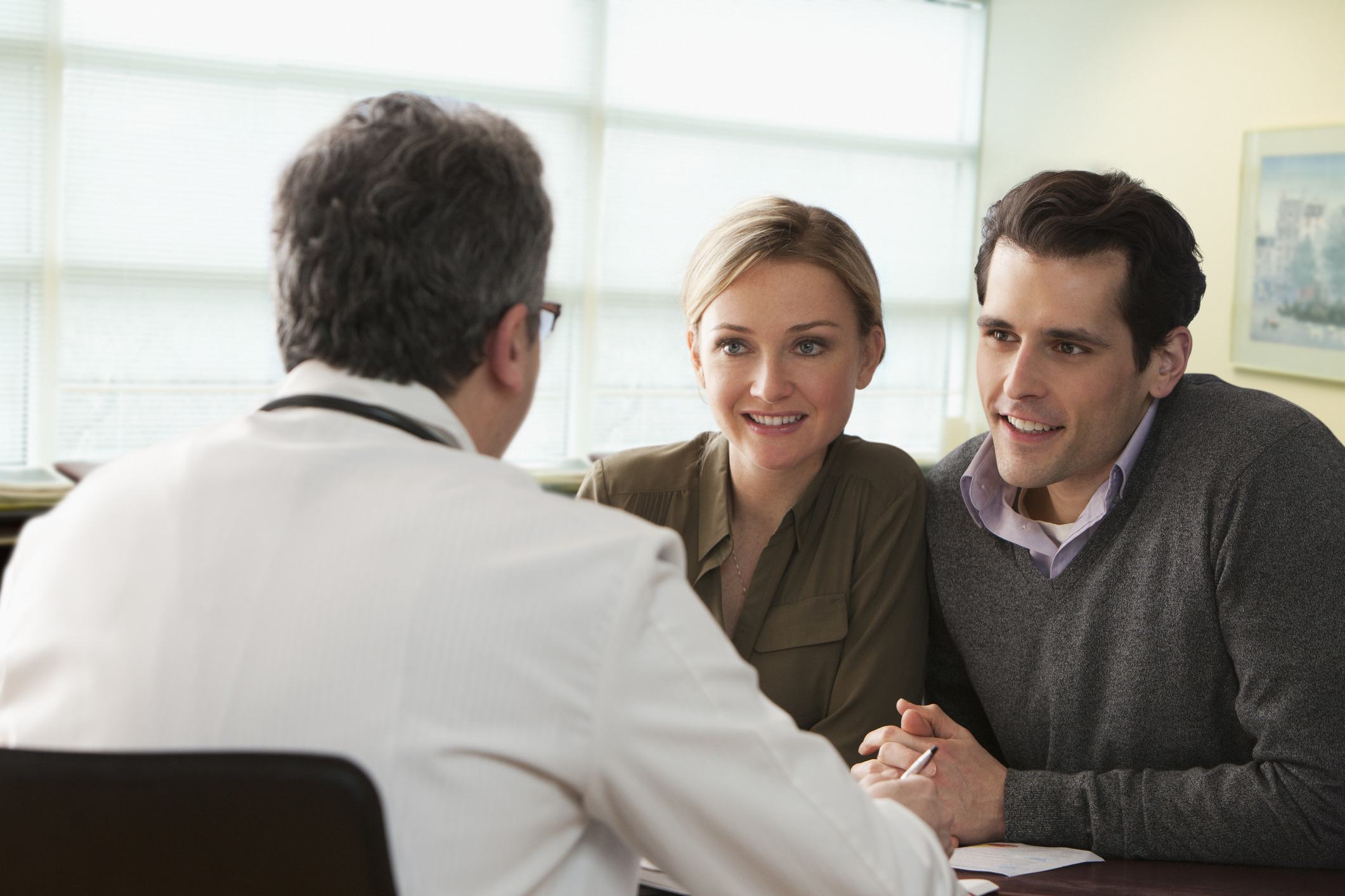 Doctor speaking to young couple