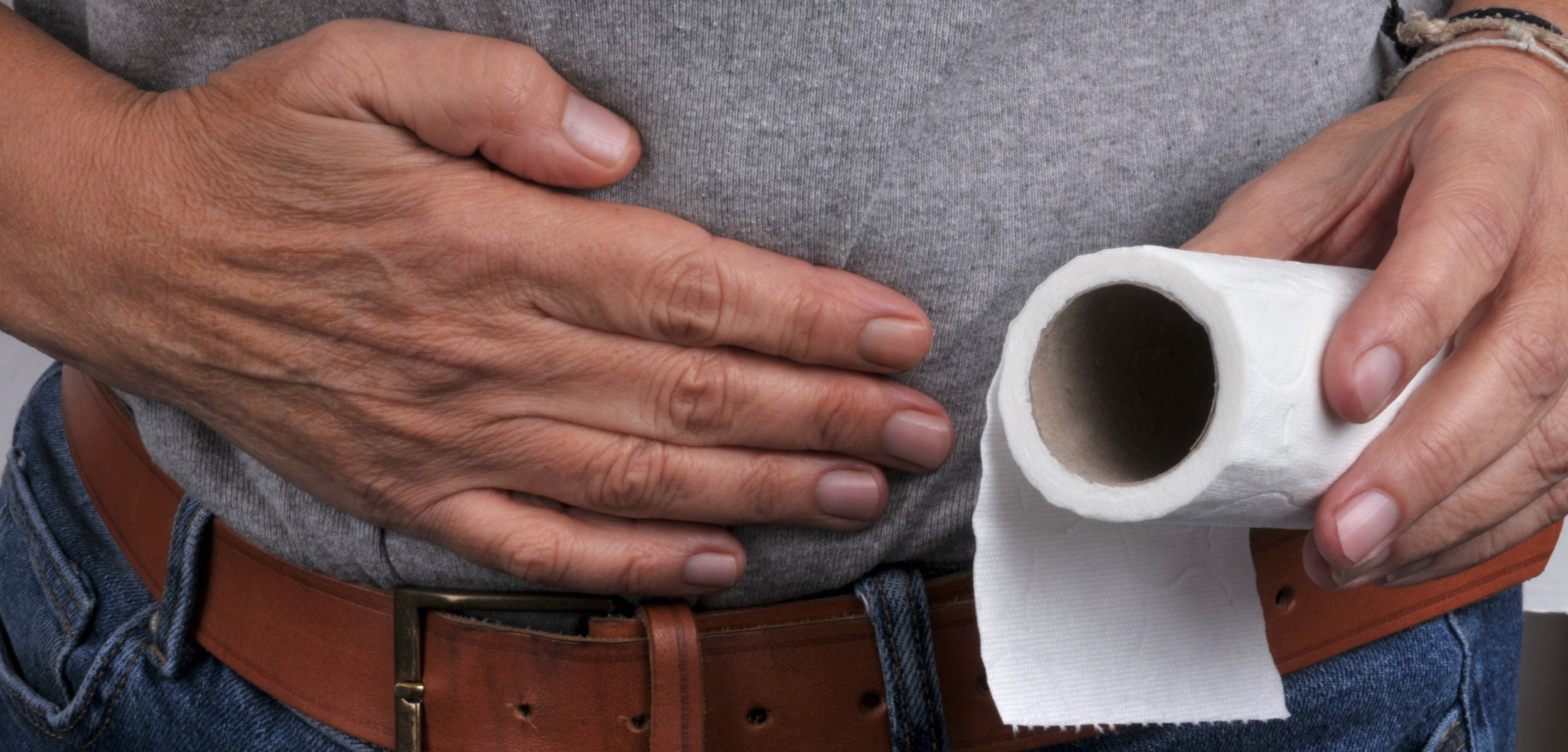 Chronic Diarrhea — Man with bowel urgency holding toilet paper